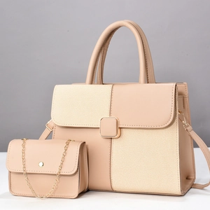 Detail of beige composite handbag set with textured fabric panels and gold hardware