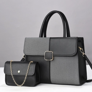Chic two-piece handbag set featuring black leather and grey fabric patchwork with gold hardware