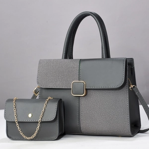 Detailed view of grey tote and mini chain bag set with contrast textures and gold hardware