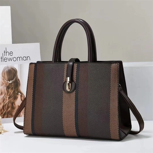 Fashionable vertical stripe tote bag with leather trim and gold buckle closure