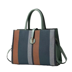 Fashionable large capacity striped canvas handbag with green leather handles and strap