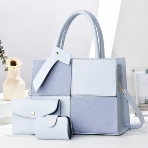 Light blue 3-piece bag set with tote, clutch, and coin purse in textured fabric and leather