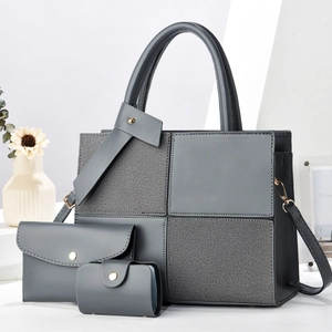 Three-piece dark grey tote bag set with textured patchwork and gold hardware details