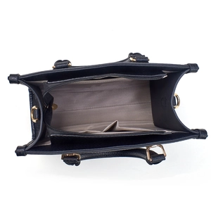 Internal view of black tote bag showing spacious grey lining and gold hardware details