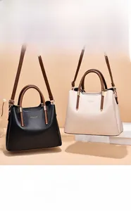 Detailed close-up of premium leather handbags with gold hardware and brand logo embossing