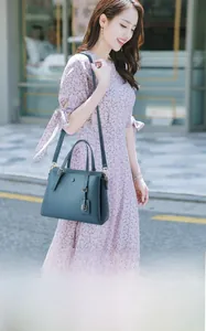 Litchi texture cowhide leather tote in dark teal with elegant gold-tone hardware detail