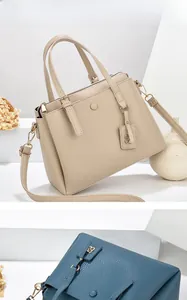 Litchi pattern leather handbags in beige and navy blue with adjustable shoulder straps