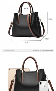 Size comparison of black tote bag with iPad and iPhone showing its dimensions