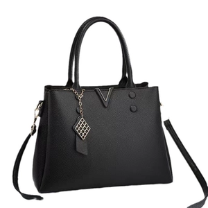 Chic black lychee leather handbag with V-shaped metal accent and quilted pendant charm