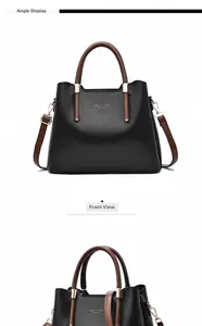 Detailed front and angle view of black leather handbag with brown handles and gold logo
