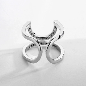 Minimalist silver geometric nail ring with micro-paved diamonds on white platform