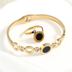 Golden Roman numeral jewelry set with black enamel and sparkling white crystals