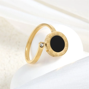 Macro detail of gold titanium ring featuring black Roman numeral dial and clear zircon
