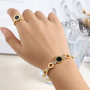 Detail of Roman numeral bangle and ring set with crystal accents on model hand