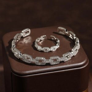 Elegant silver open bangle and ring set with hollow geometric links and pavé zircons