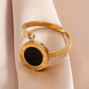 Golden Roman numeral open ring with black disc and sparkling diamond accent