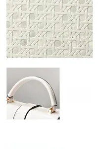 Detail of woven lattice texture on white bucket bag with elegant golden hardware