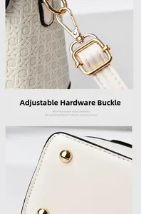 Detail of woven leather texture, gold hardware and protective metal feet on bucket bag