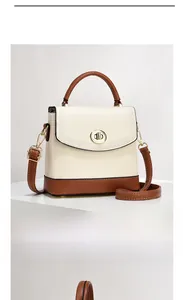 Detailed view of bicolor leather bucket bag with litchi texture and gold lock