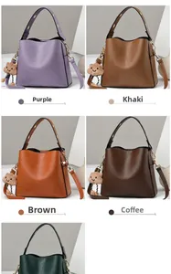 Detail showing five colors of leather bucket bags with plush cloud charms and side zippers