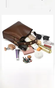 Detailed view of the brown bucket bag's large interior space with various daily essentials