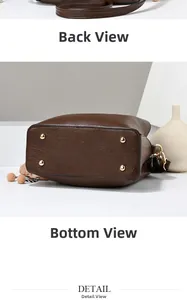 Detailed view of brown textured leather bag base with gold feet and side profile