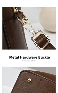 Detail view of premium gold-toned hardware hooks and rivets on brown leather bucket bag