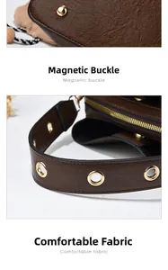 Detail of dark brown leather bucket bag showing gold rivets and hollow metal ring handles