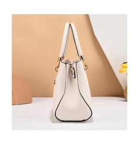 Detail of cream white leather tote showing crocodile pattern texture and gold D-ring