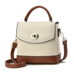 Contrast color trapezoidal bucket bag in beige and brown pebbled leather with gold lock
