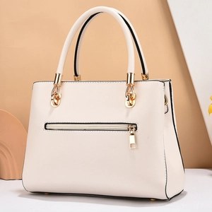 Elegant off-white faux leather handbag with gold hardware and back zipper pocket