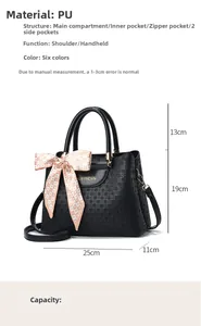 Detailed view of black woven texture handbag with internal compartments and silk scarf