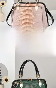 Detail of lizard embossed leather shell bag showing gold hardware and texture