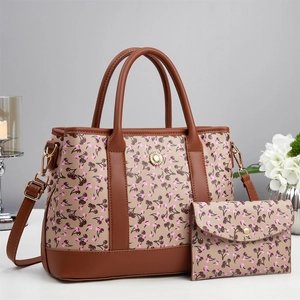 Elegant cherry print tote bag and pouch set with adjustable strap on white surface