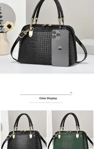 Lizard embossed leather handbag set in black and dark green with golden hardware