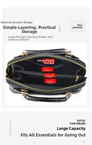 Internal structure of black lizard pattern handbag showing multi-compartment storage space