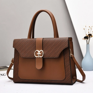 Caramel brown monogram tote bag with gold GT buckle and adjustable shoulder strap