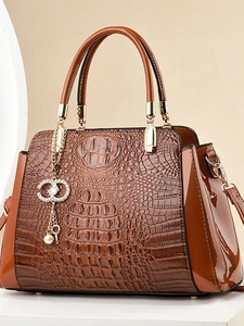 Brown crocodile pattern tote bag with glossy leather details and gold hardware accessories