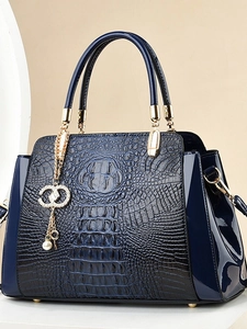 Navy blue crocodile pattern tote bag with glossy leather sides and gold accents