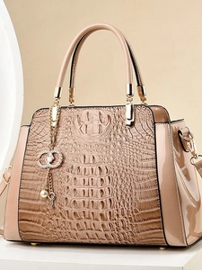 Beige crocodile texture handbag with glossy patent leather trim and pearl tassel charm