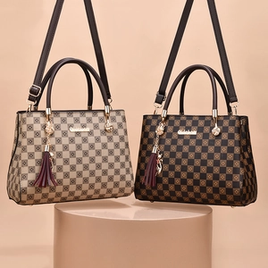 Checkerboard pattern tote bag with metal logo and tassel strap in two colorways