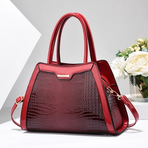 Elegant deep red crocodile pattern handbag with gold hardware and detachable strap