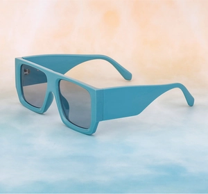 Detail of wide temple square sunglasses in light blue glossy finish with dark grey lenses