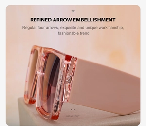 Detail view of pink transparent oversized sunglasses with wide temples and silver arrow decor