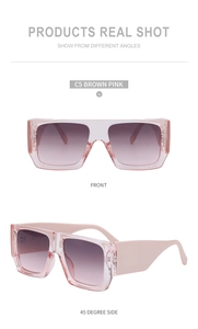 Detail shot of wide-leg fashion sunglasses with pink transparent frame and purple lenses