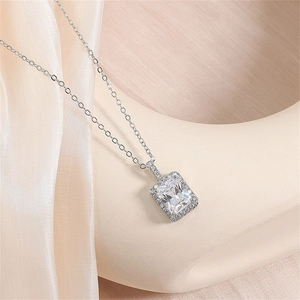 Macro shot of silver emerald-cut cubic zirconia pendant with fine chain details