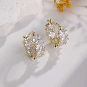 Sparkling gold hoop earrings with pavé square cubic zirconia on a minimalist stone base