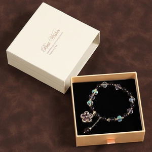 Purple crystal star bracelet with flower pendant inside a premium gift box packaging