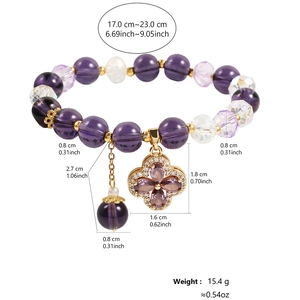Detail of purple crystal star bracelet showing clover pendant with violet gemstones