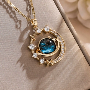 Golden starry sky necklace with blue celestial sphere and crystal-encrusted crescent moon